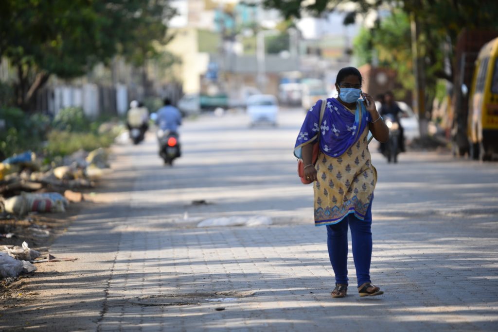 A woman wears a mask while venturing out for some work