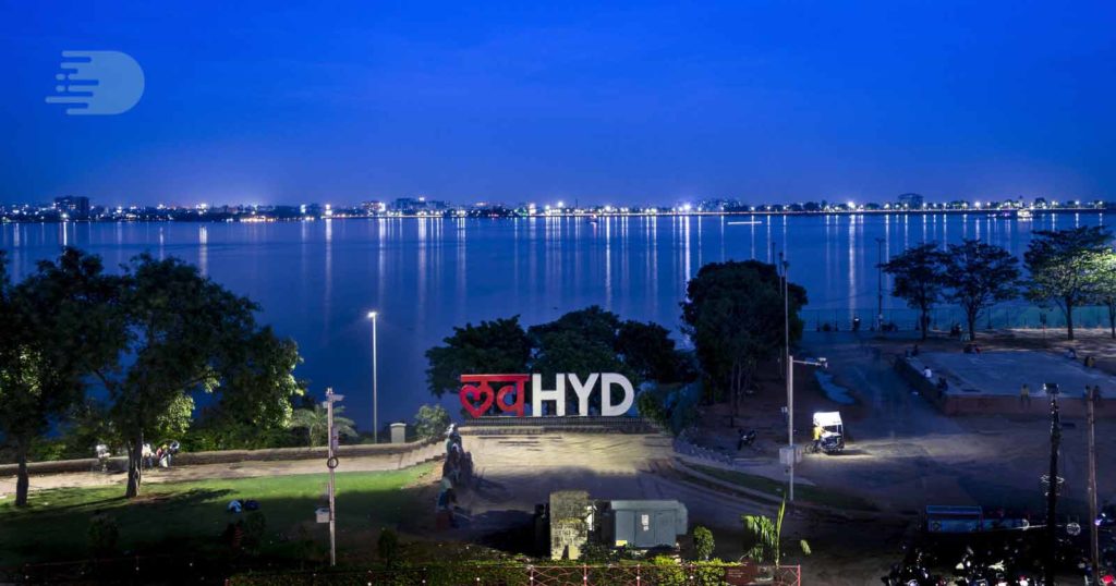 Hussain Sagar lake in Hyderabad seen at night, with the Love Hyderabad signboard in the foreground