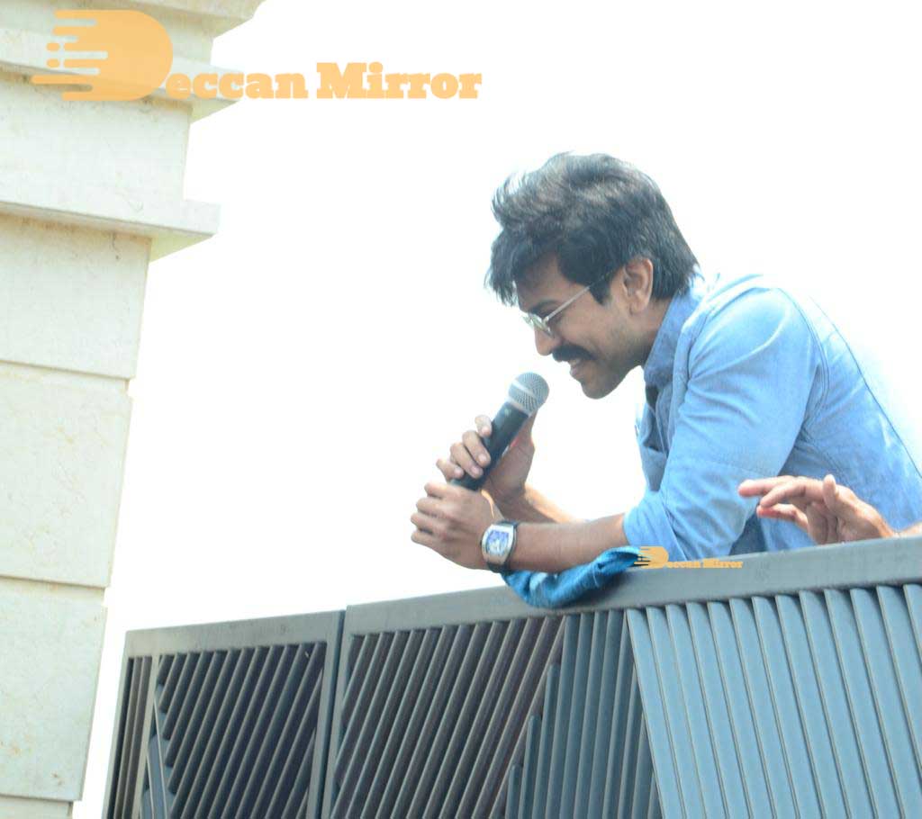 Ram Charan Tej greets his fans from over the Gate