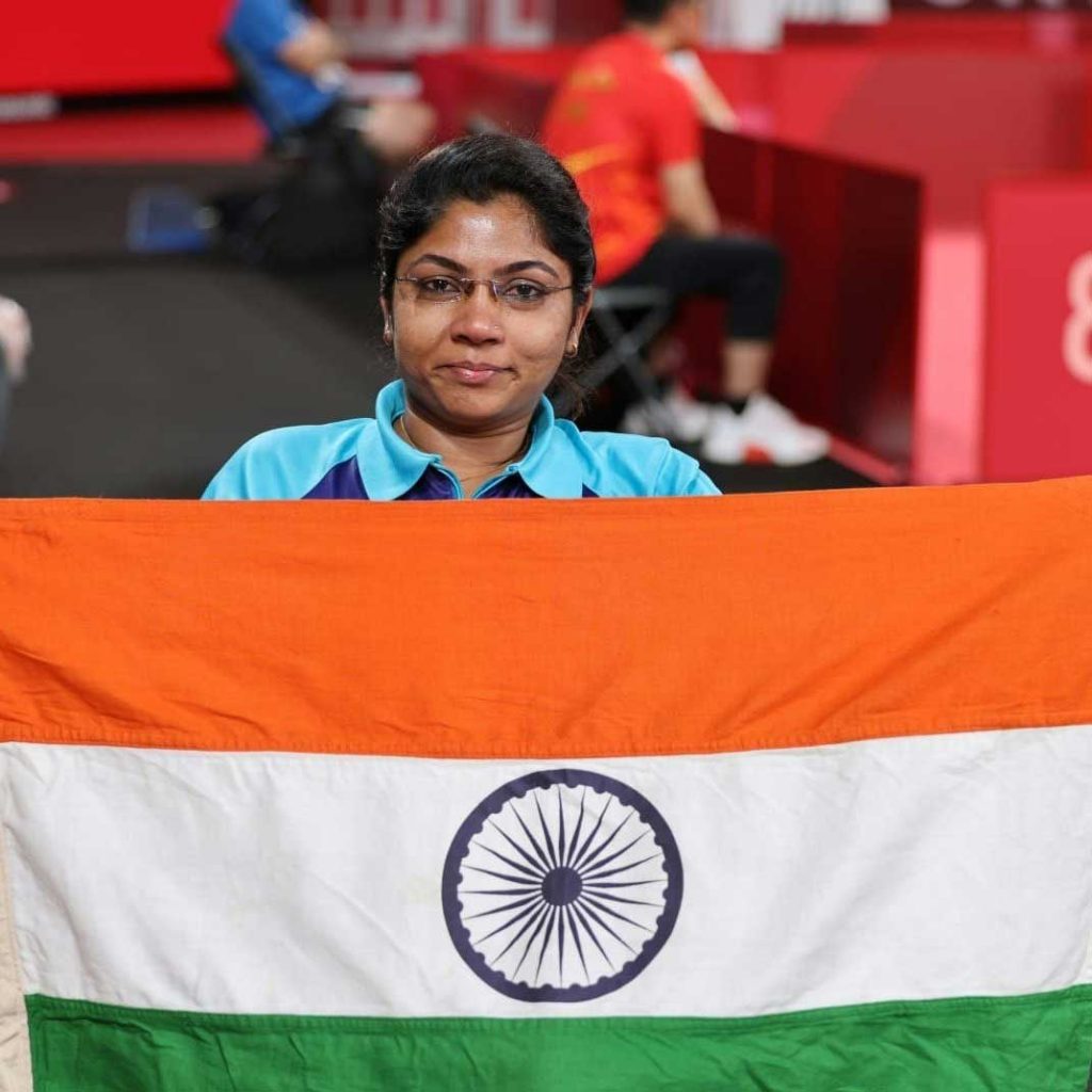 Bhavina Patel holds the Indian flag after being assured of a medal by reaching the semifinals in Table Tennis