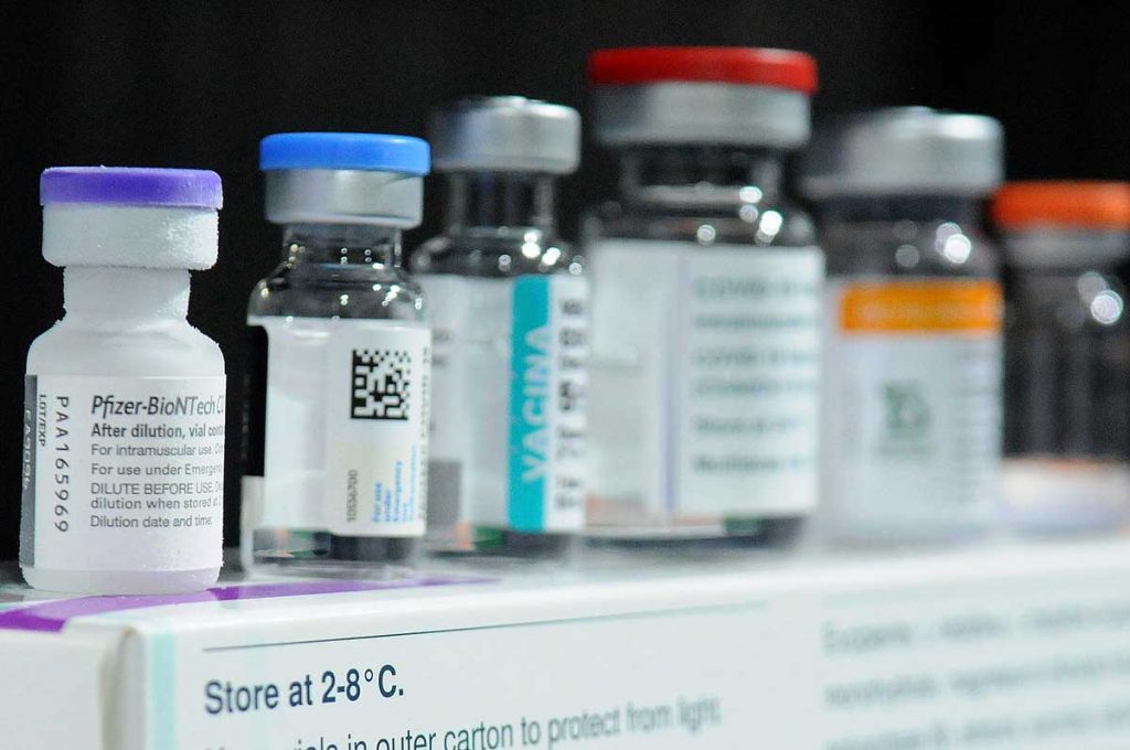 COVID-19 vaccine bottles including Pfizer