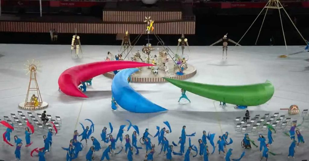 Performers bring three Agitos together to form the symbol of the Paralympic Games
