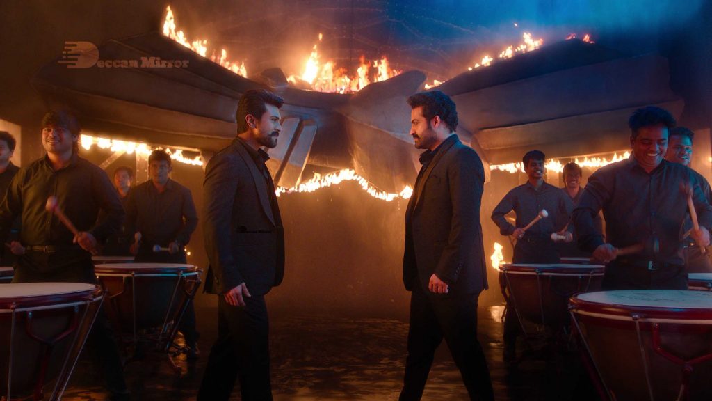 Junior NTR and Ram Charan Teja, dressed in black suits, make a special appearance in the promotional video for the movie RRR featuring Dosti song