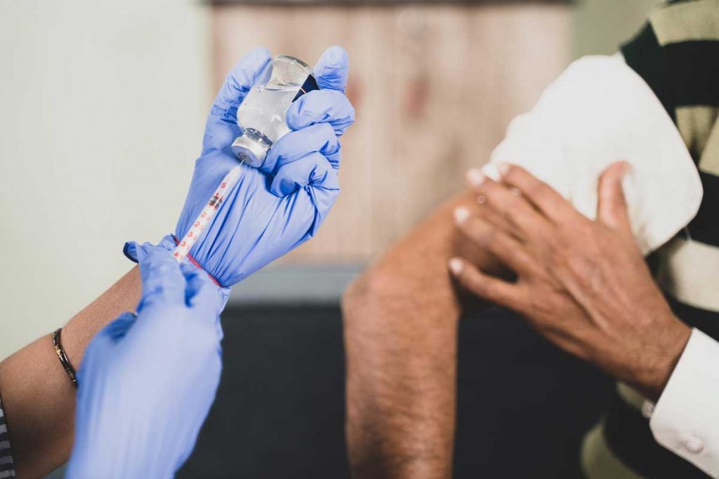 A person receiving a vaccination jab