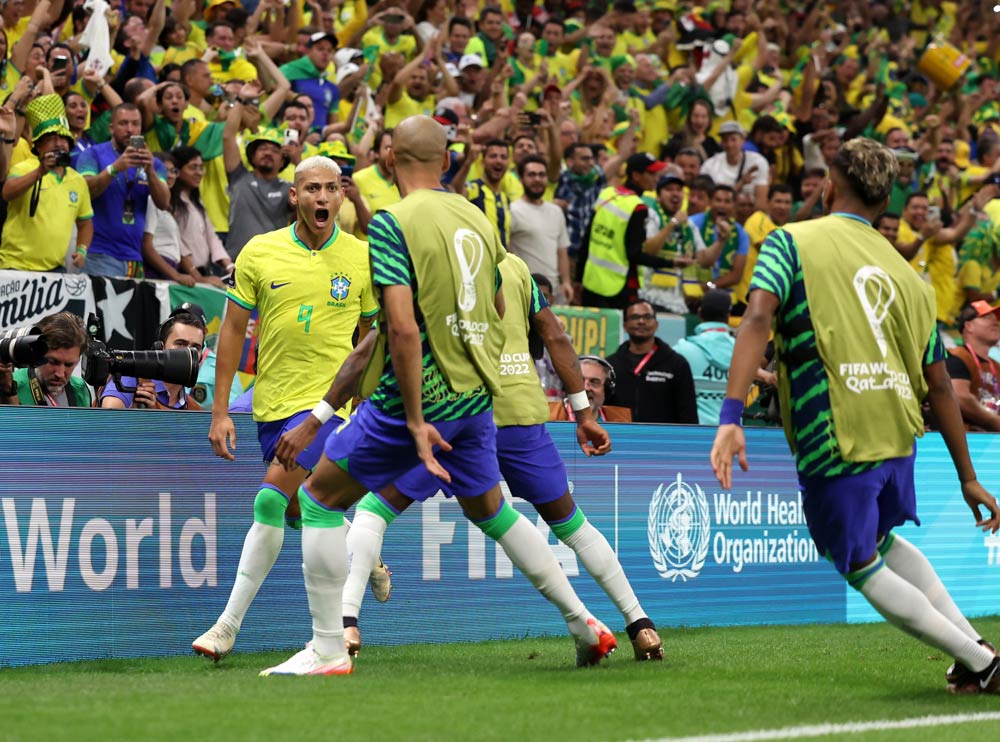 Brazilian players celebrate their first goal against Serbia