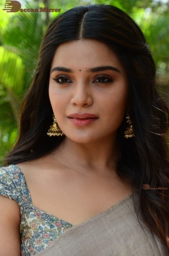 Telugu and Tamil actress Aathmika posing in a Grey Saree