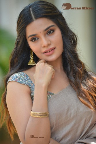 Telugu and Tamil actress Aathmika posing in a Grey Saree