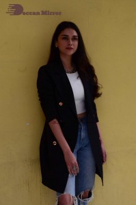 Aditi Rao pictures in white top, blue jeans and black overcoat