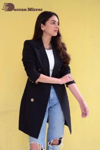 Aditi Rao pictures in white top, blue jeans and black overcoat