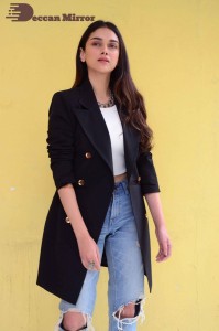 Aditi Rao pictures in white top, blue jeans and black overcoat