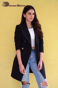 Aditi Rao pictures in white top, blue jeans and black overcoat