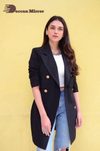 Aditi Rao pictures in white top, blue jeans and black overcoat