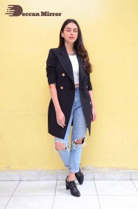 Aditi Rao pictures in white top, blue jeans and black overcoat