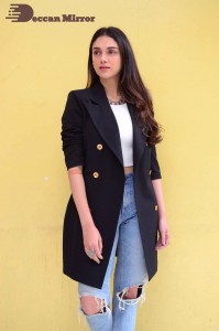 Aditi Rao pictures in white top, blue jeans and black overcoat