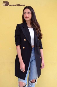 Aditi Rao pictures in white top, blue jeans and black overcoat