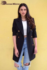 Aditi Rao pictures in white top, blue jeans and black overcoat