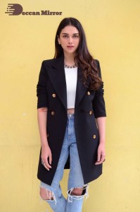 Aditi Rao pictures in white top, blue jeans and black overcoat