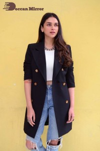 Aditi Rao pictures in white top, blue jeans and black overcoat