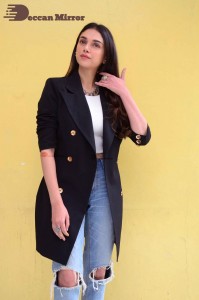 Aditi Rao pictures in white top, blue jeans and black overcoat