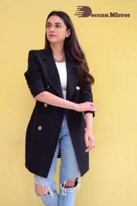 Aditi Rao pictures in white top, blue jeans and black overcoat