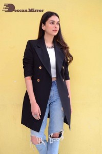 Aditi Rao pictures in white top, blue jeans and black overcoat