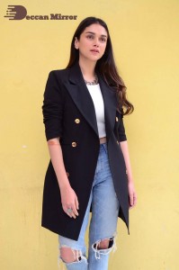 Aditi Rao pictures in white top, blue jeans and black overcoat