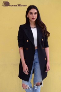 Aditi Rao pictures in white top, blue jeans and black overcoat