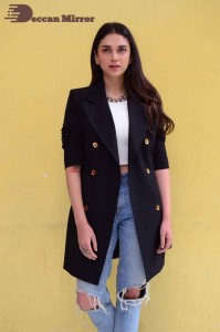 Aditi Rao pictures in white top, blue jeans and black overcoat