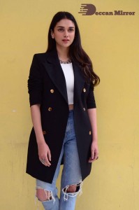 Aditi Rao pictures in white top, blue jeans and black overcoat
