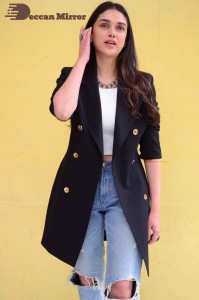 Aditi Rao pictures in white top, blue jeans and black overcoat