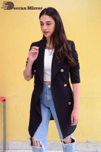 Aditi Rao pictures in white top, blue jeans and black overcoat