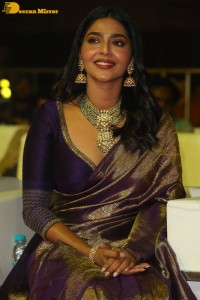 Actress Aishwarya Lekshmi in a purple saree at the pre-release event of Ponniyin Selvan