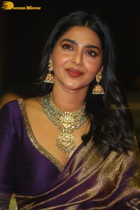 Actress Aishwarya Lekshmi in a purple saree at the pre-release event of Ponniyin Selvan