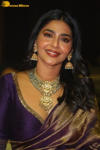 Actress Aishwarya Lekshmi in a purple saree at the pre-release event of Ponniyin Selvan