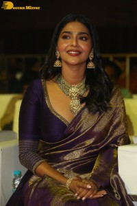 Actress Aishwarya Lekshmi in a purple saree at the pre-release event of Ponniyin Selvan