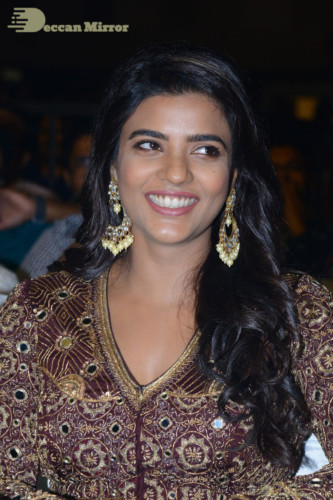 Actress Aishwarya Rajesh posing for a photoshoot in a dark brown dress