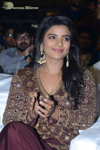 Actress Aishwarya Rajesh posing for a photoshoot in a dark brown dress