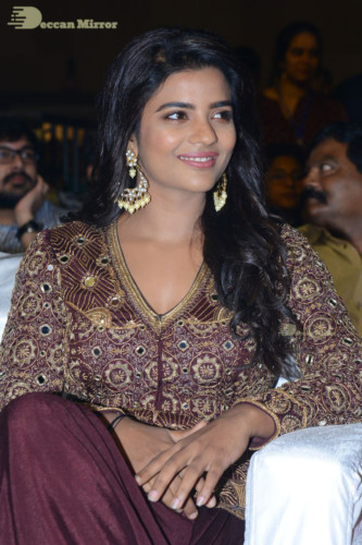 Actress Aishwarya Rajesh posing for a photoshoot in a dark brown dress