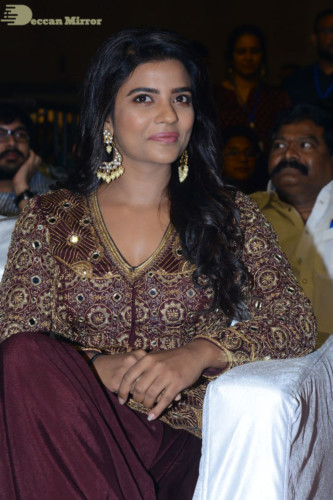 Actress Aishwarya Rajesh posing for a photoshoot in a dark brown dress