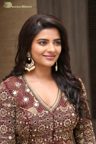 Actress Aishwarya Rajesh posing for a photoshoot in a dark brown dress