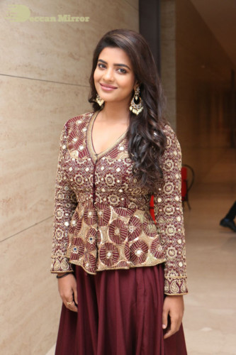 Actress Aishwarya Rajesh posing for a photoshoot in a dark brown dress