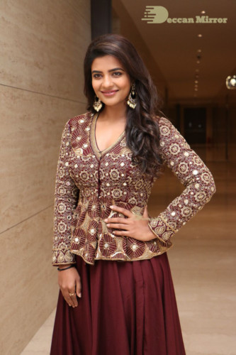Actress Aishwarya Rajesh posing for a photoshoot in a dark brown dress