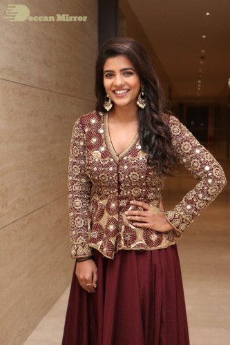Actress Aishwarya Rajesh posing for a photoshoot in a dark brown dress