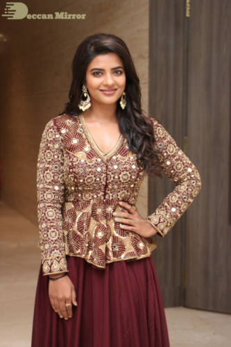 Actress Aishwarya Rajesh posing for a photoshoot in a dark brown dress