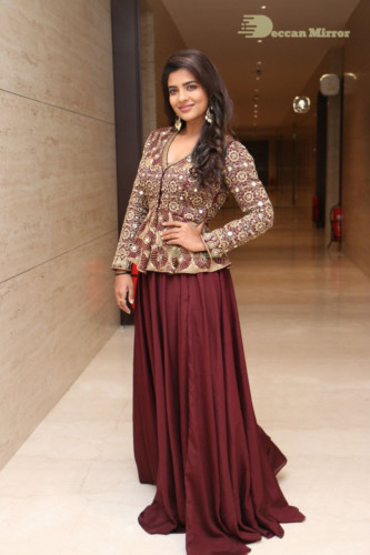 Actress Aishwarya Rajesh posing for a photoshoot in a dark brown dress