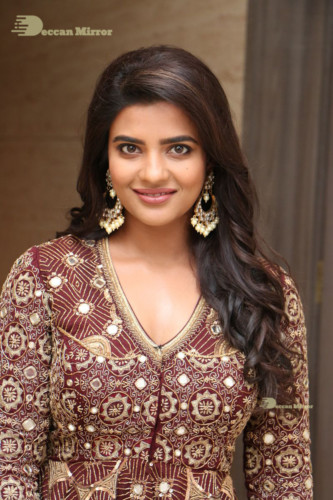 Actress Aishwarya Rajesh posing for a photoshoot in a dark brown dress
