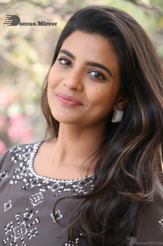 Heroine Aishwarya Rajesh poses for pictures in a brown dress