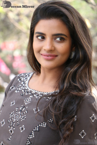 Heroine Aishwarya Rajesh poses for pictures in a brown dress