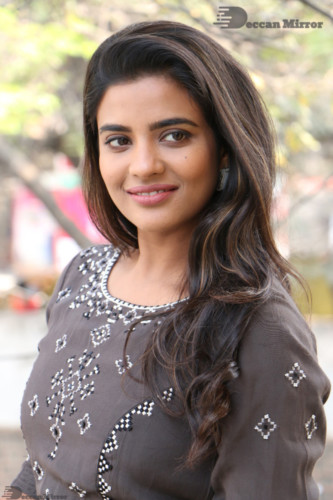 Heroine Aishwarya Rajesh poses for pictures in a brown dress