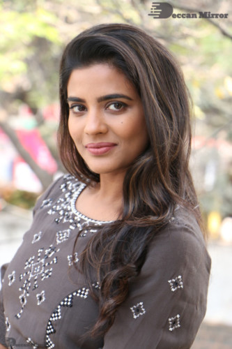 Heroine Aishwarya Rajesh poses for pictures in a brown dress